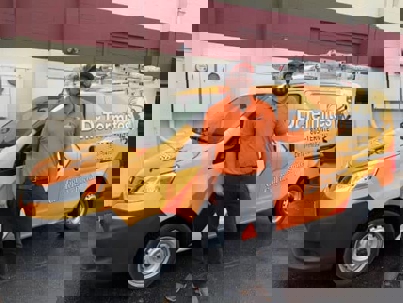 Dr. Termites technician in front of his truck